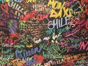 A wall covered in graffiti. Photo by Andreas Fickl on Unsplash