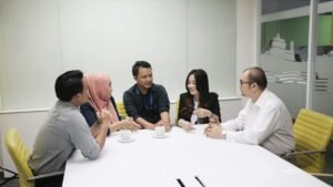 Nonprofit team talking in an office meeting, smiling. Edi Kurniawan photo
