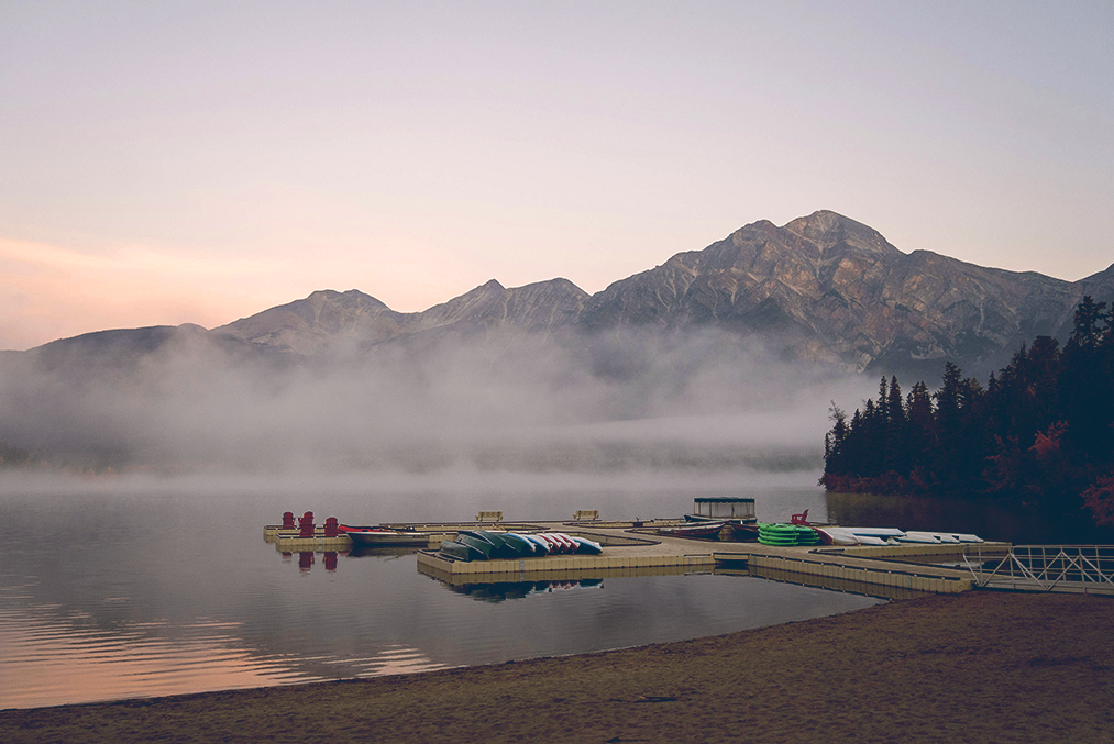 Still water and a dock at dawn, Pacific Northwest — Davey Gravy on Unsplash