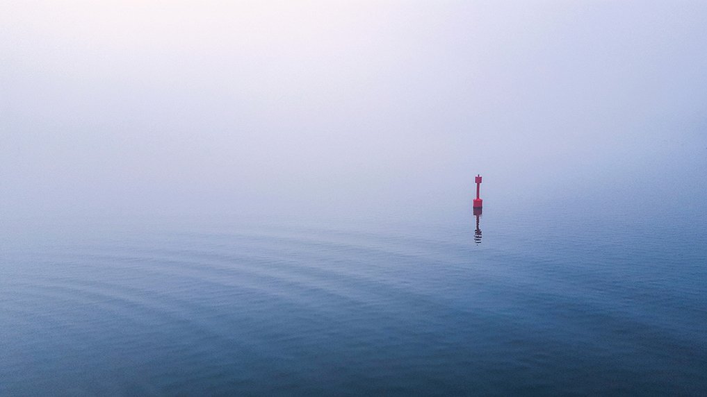 A red buoy on a body of water during daytime. Photo credit Mark de John.